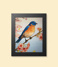 Bluebird and cherry blossoms framed poster with black frame on a cream background