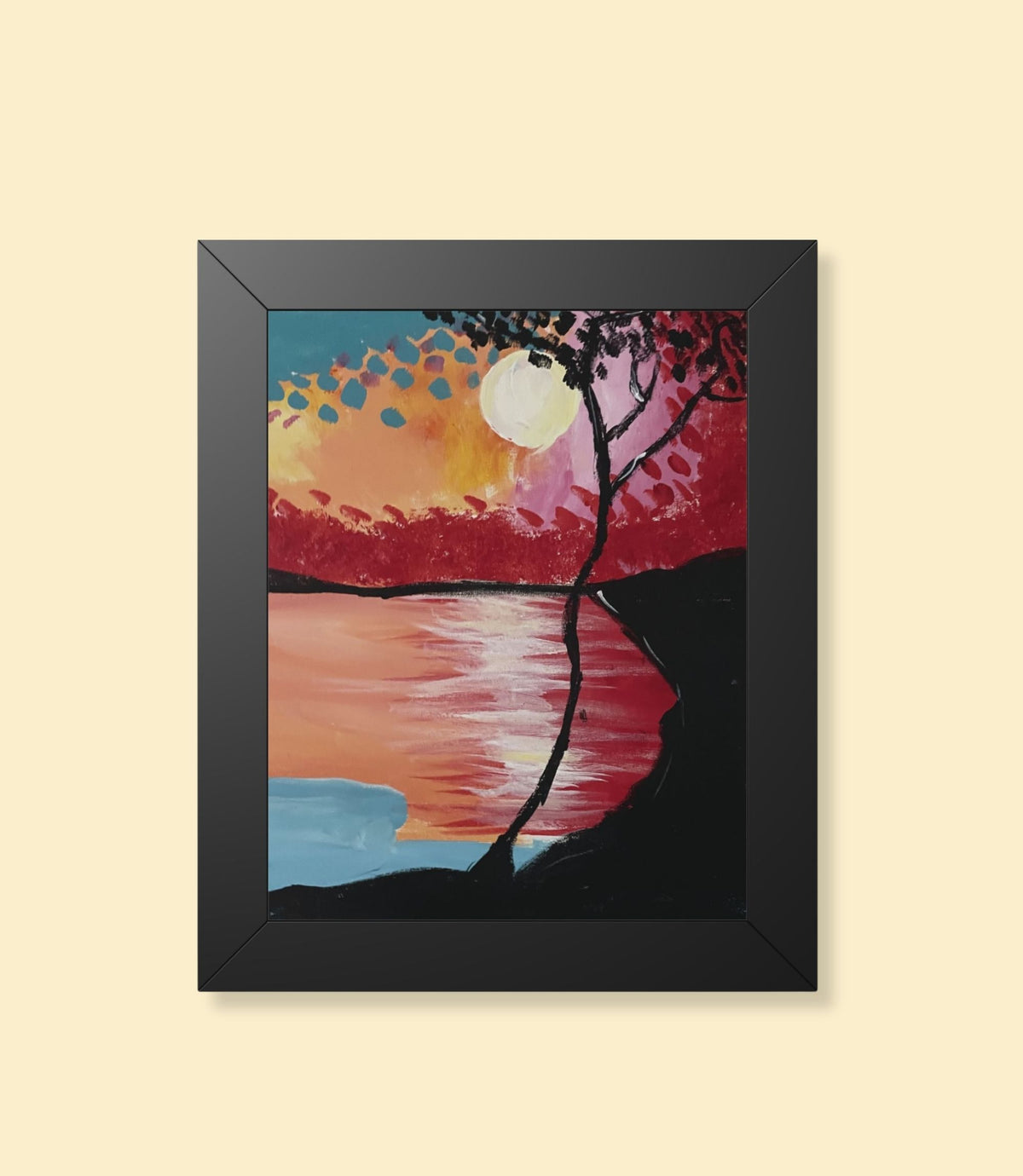 Sunset lake and silhouetted tree framed poster with black frame on a cream background