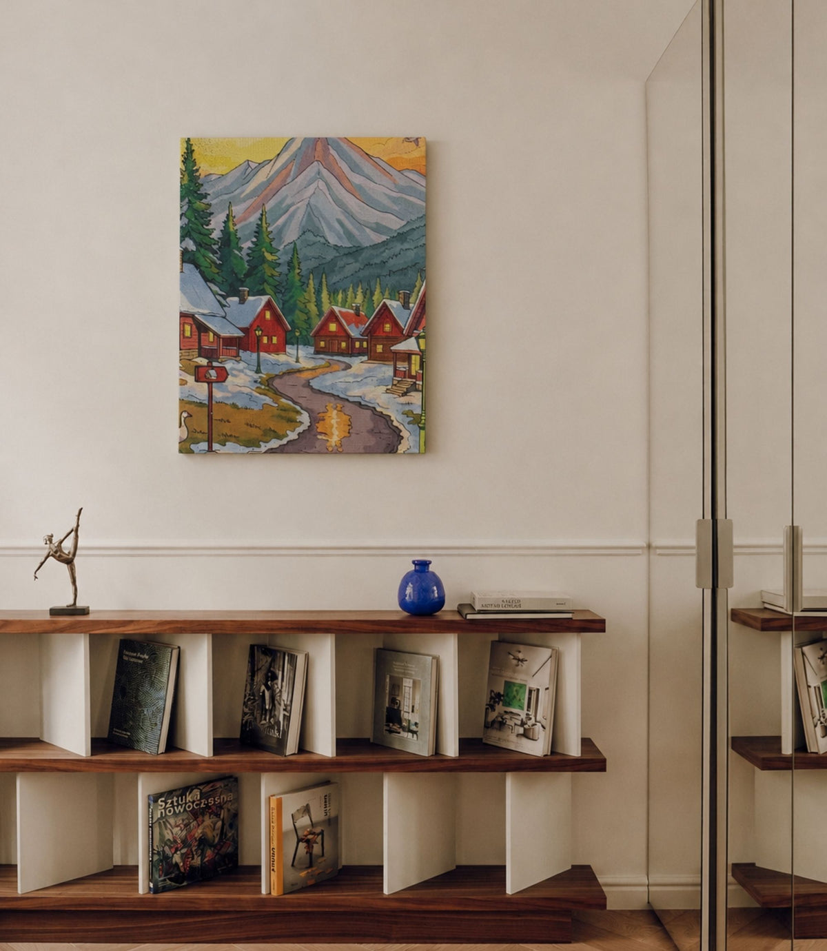 Winter mountain village canvas displayed in a modern interior