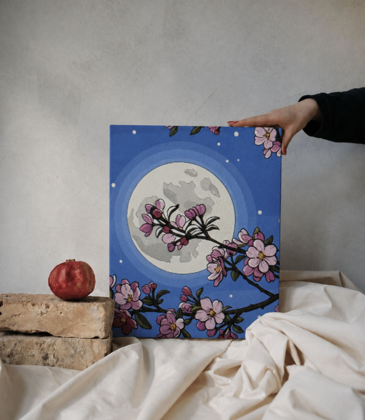 Person holding cherry blossom moon stretched canvas wall art