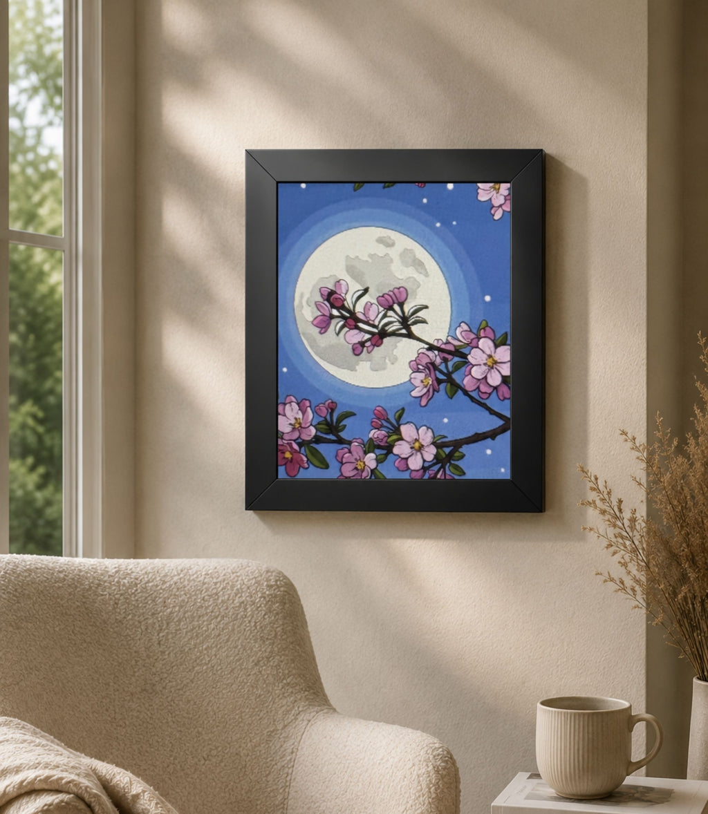 Black-framed cherry blossom moon poster displayed in a modern interior
