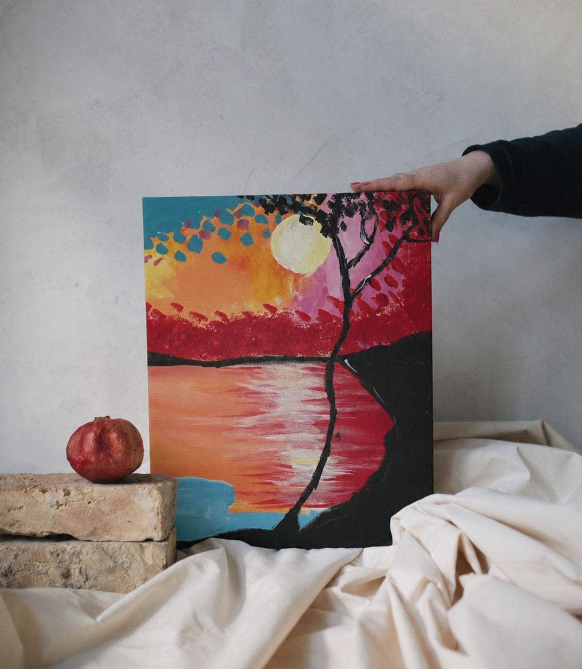 Person holding sunset lake and silhouetted tree stretched canvas wall art