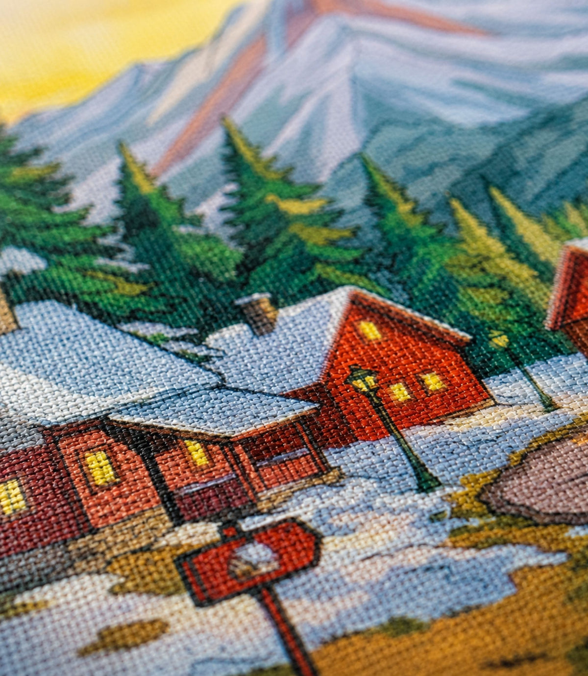 Close-up of winter mountain village artwork and matte canvas texture