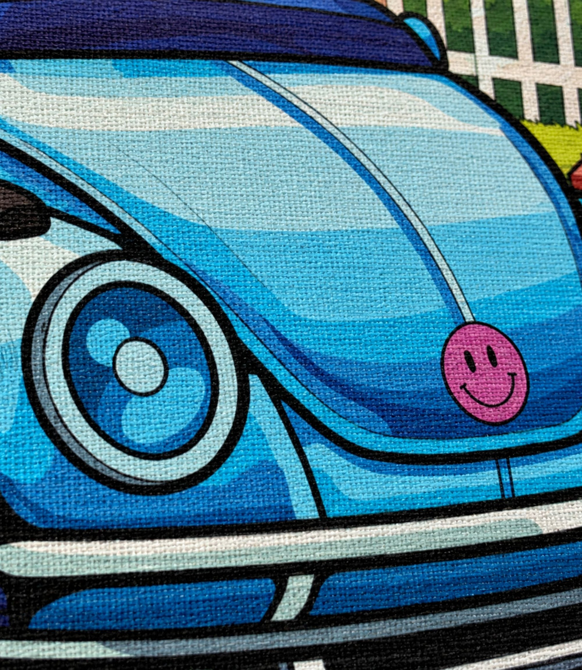 Close-up of blue bug car artwork and matte canvas texture
