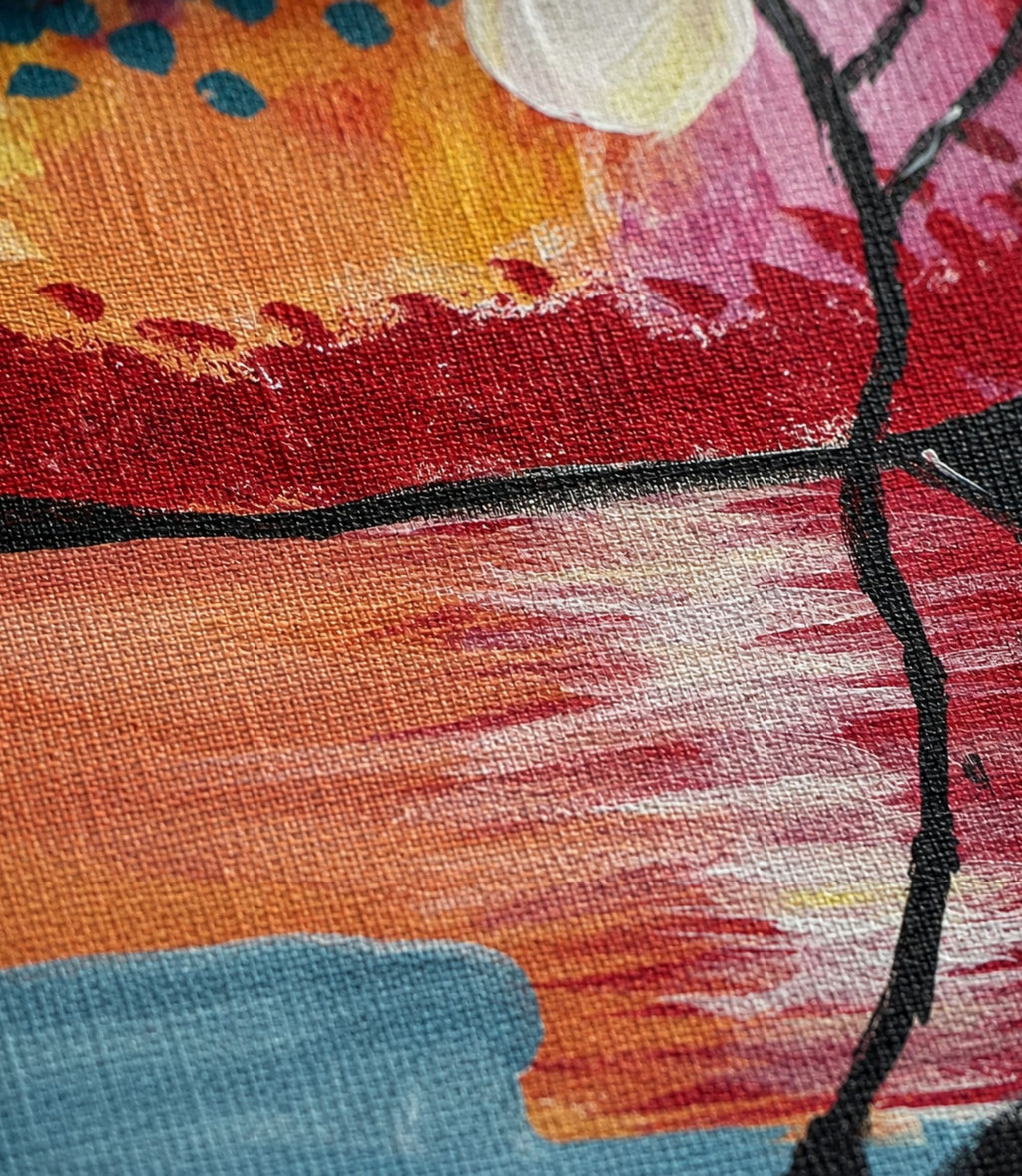 Close-up of sunset lake and silhouetted tree artwork and matte canvas texture
