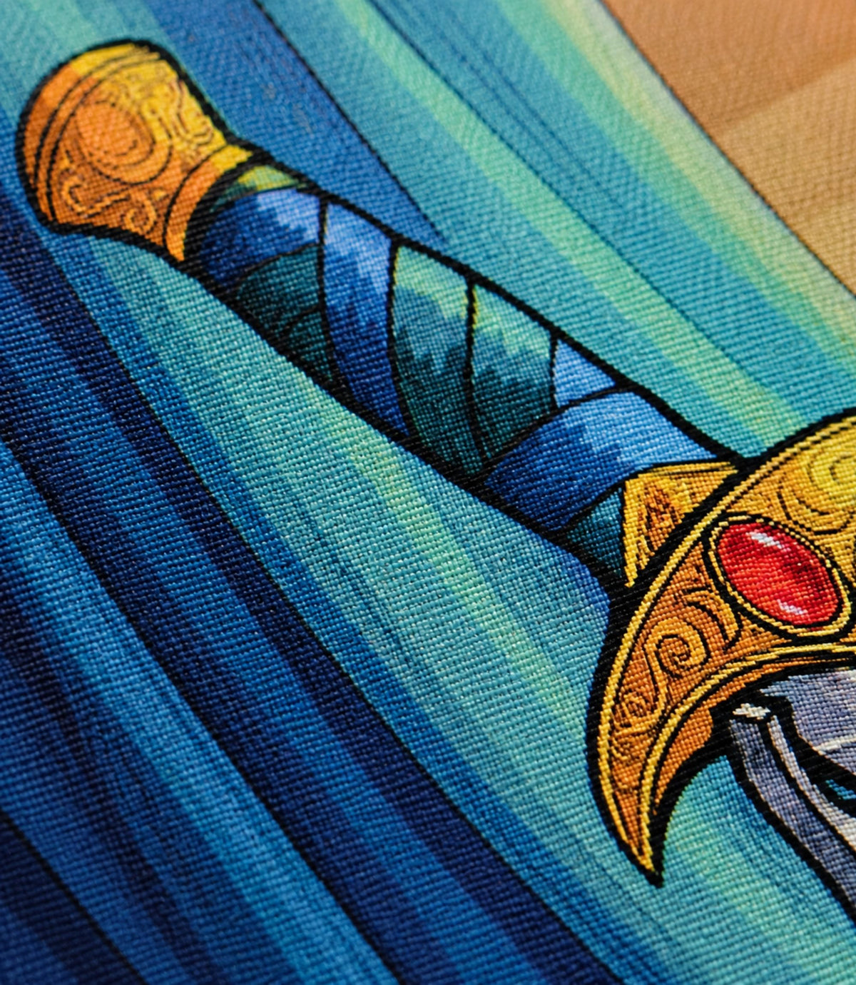 Close-up of regal fantasy sword artwork and matte canvas texture