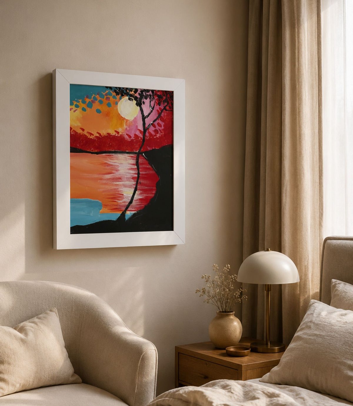 White-framed sunset lake and silhouetted tree poster displayed in a modern interior