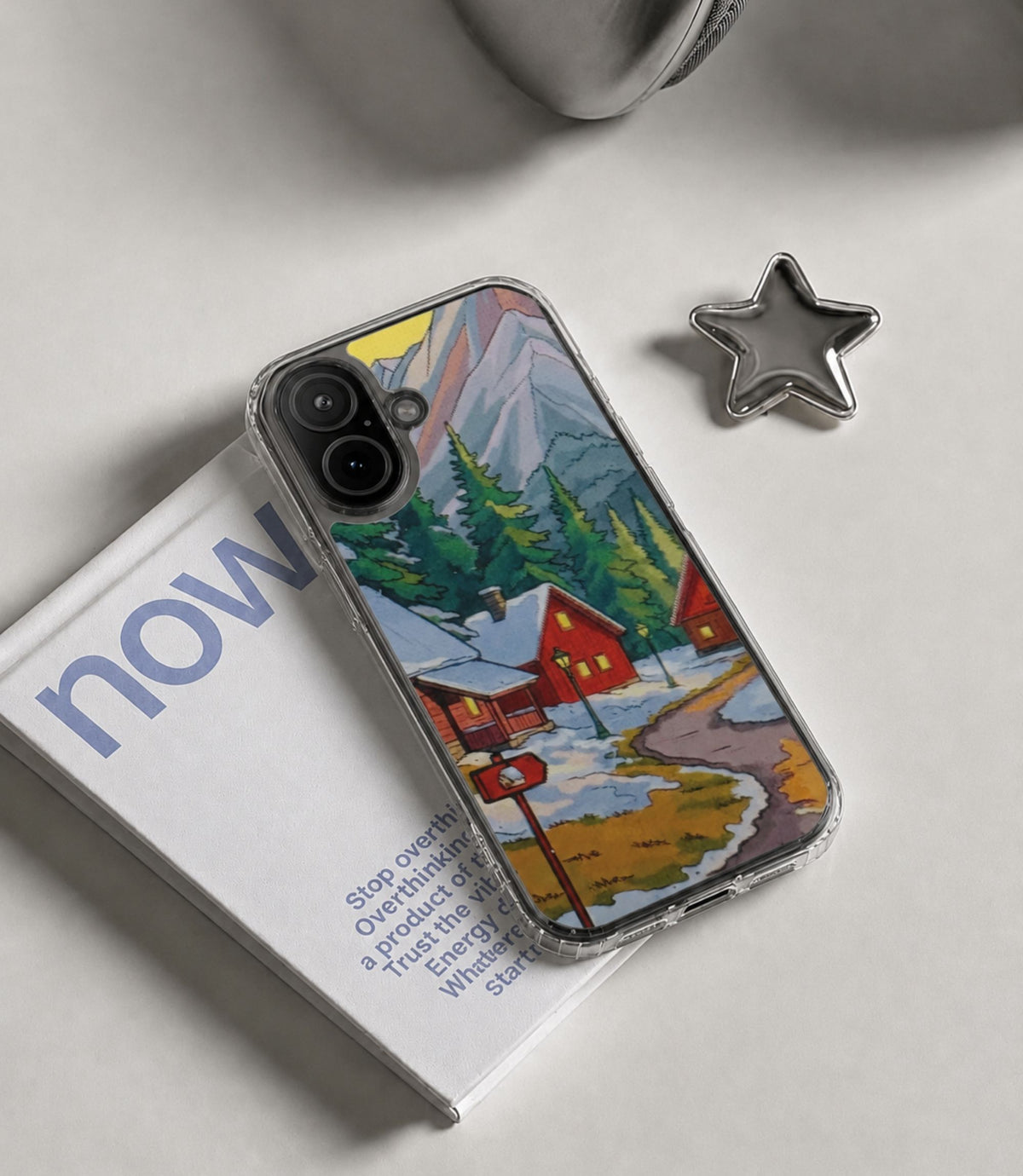 Winter mountain village clear phone case styled in an everyday lifestyle scene