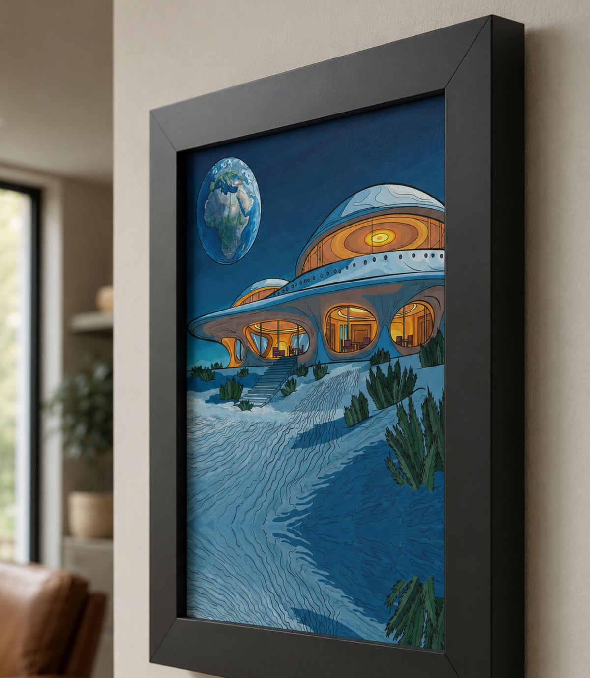 Close-up side view of black-framed retro space house art print