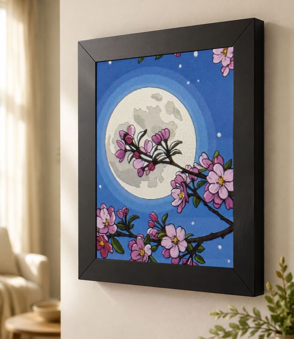 Close-up side view of black-framed cherry blossom moon art print