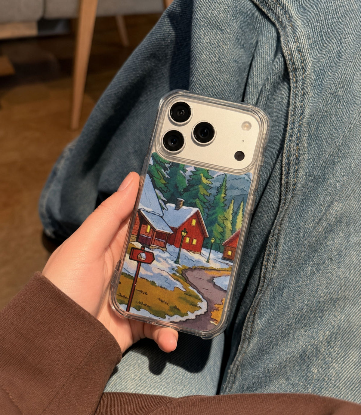 Person holding winter mountain village clear magnetic phone case